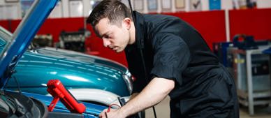 apprentice working on car engine 