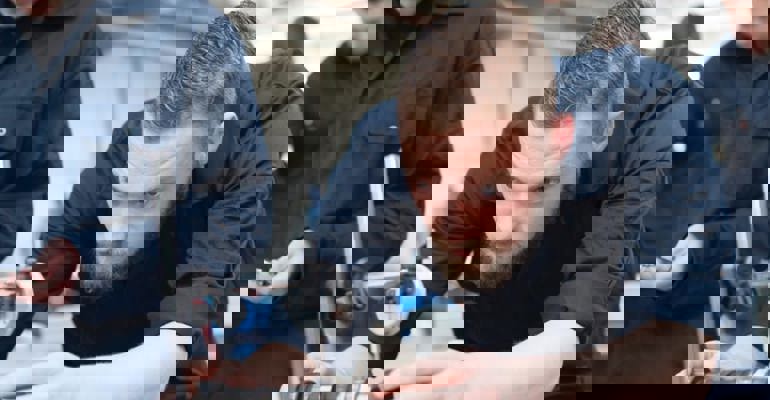 Apprentice looking at car part