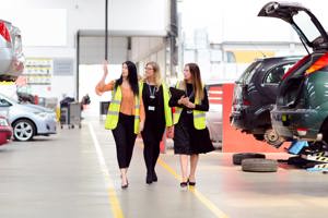 GTG Health and Safety advisors and client wearing hi-vis walking through workshop