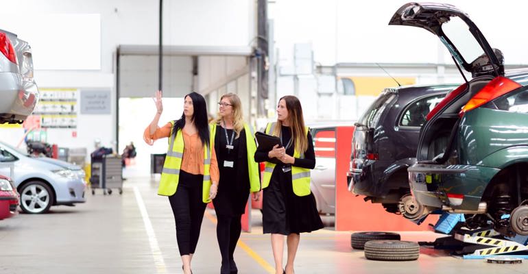 GTG Health and Safety advisors and client wearing hi-vis walking through workshop