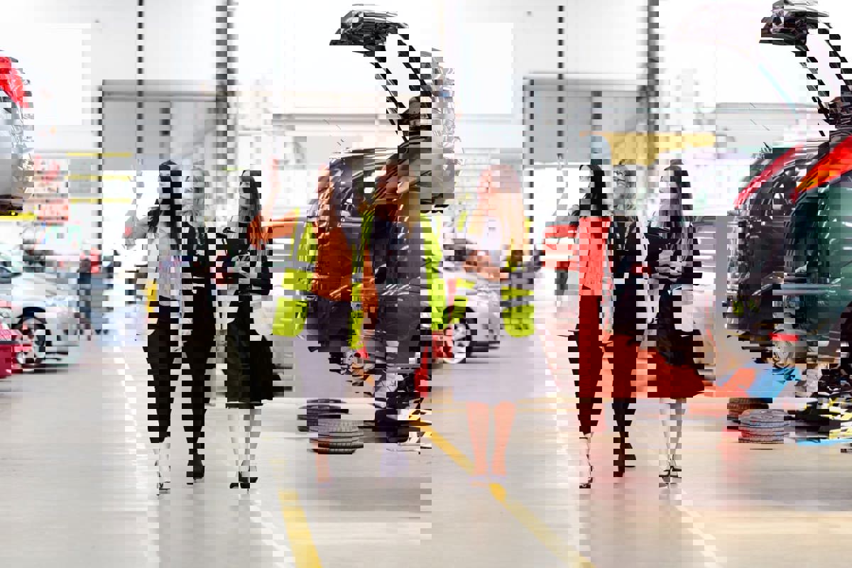 GTG Health and Safety advisors and client wearing hi-vis walking through workshop