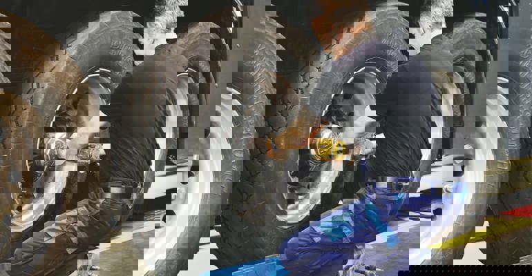 Man changing truck tyre