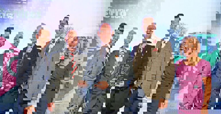 GTG Trainee winning a prize on stage with the speakers