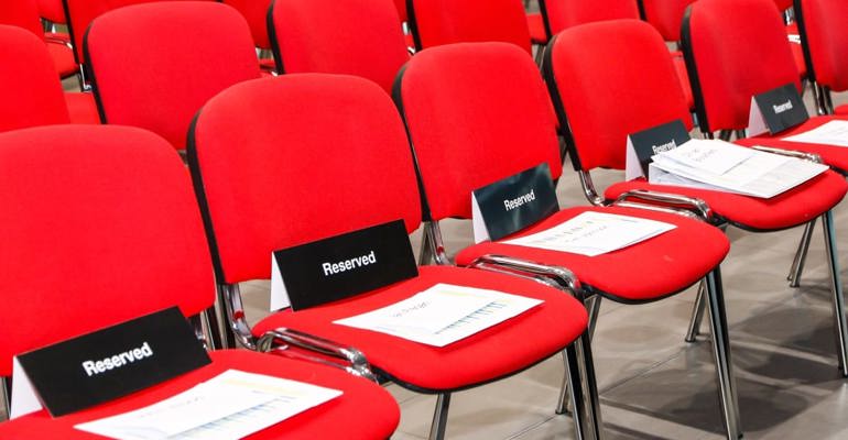 red chairs with reserved signs