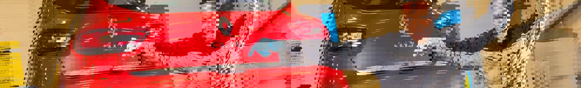 apprentice jumping in front of a car on a ramp