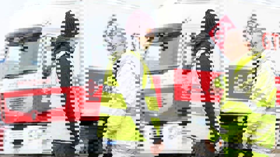 two men in front of GTG training lorry