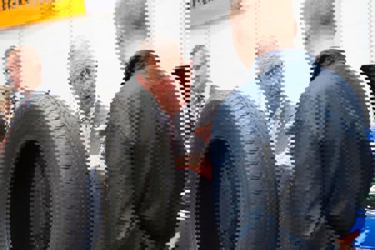 Prince Charles speaking to an apprentice next to car tyre