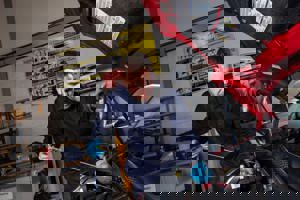 Apprentice checking the engine oil in a car