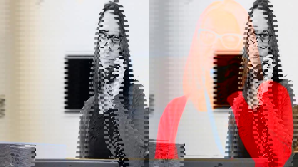 woman talking on a phone in an office