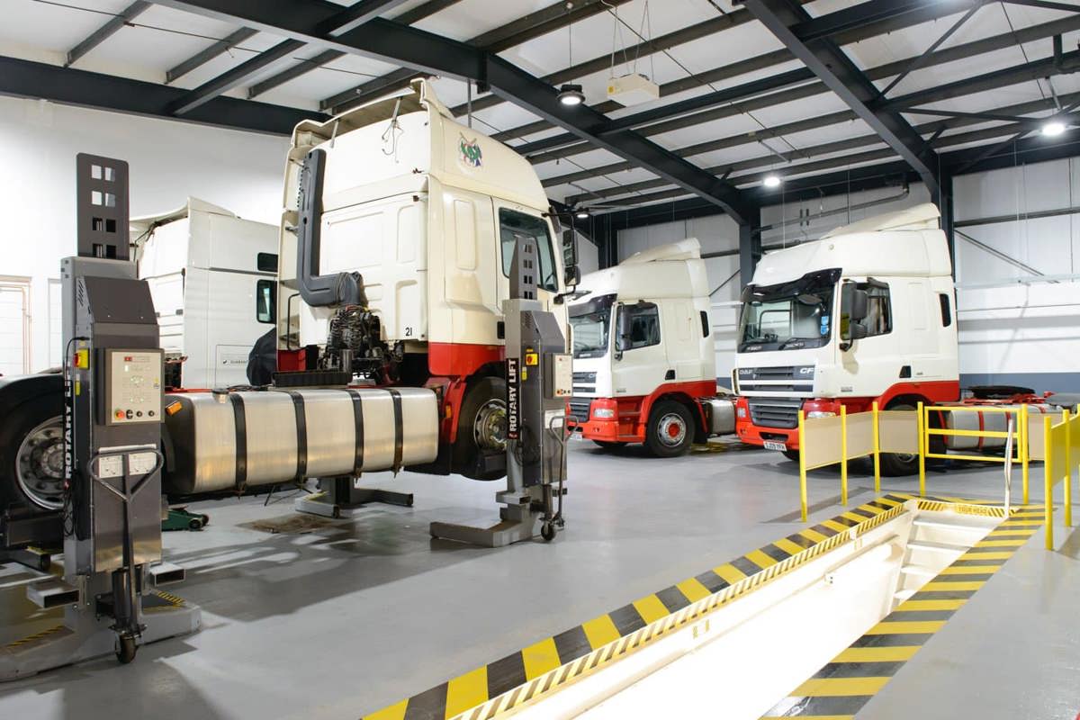 4 HGV's on ramps in the Kilbirnie Street workshop